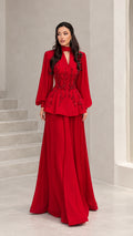 Front full view of woman wearing elegant red long-sleeve beaded peplum evening gown