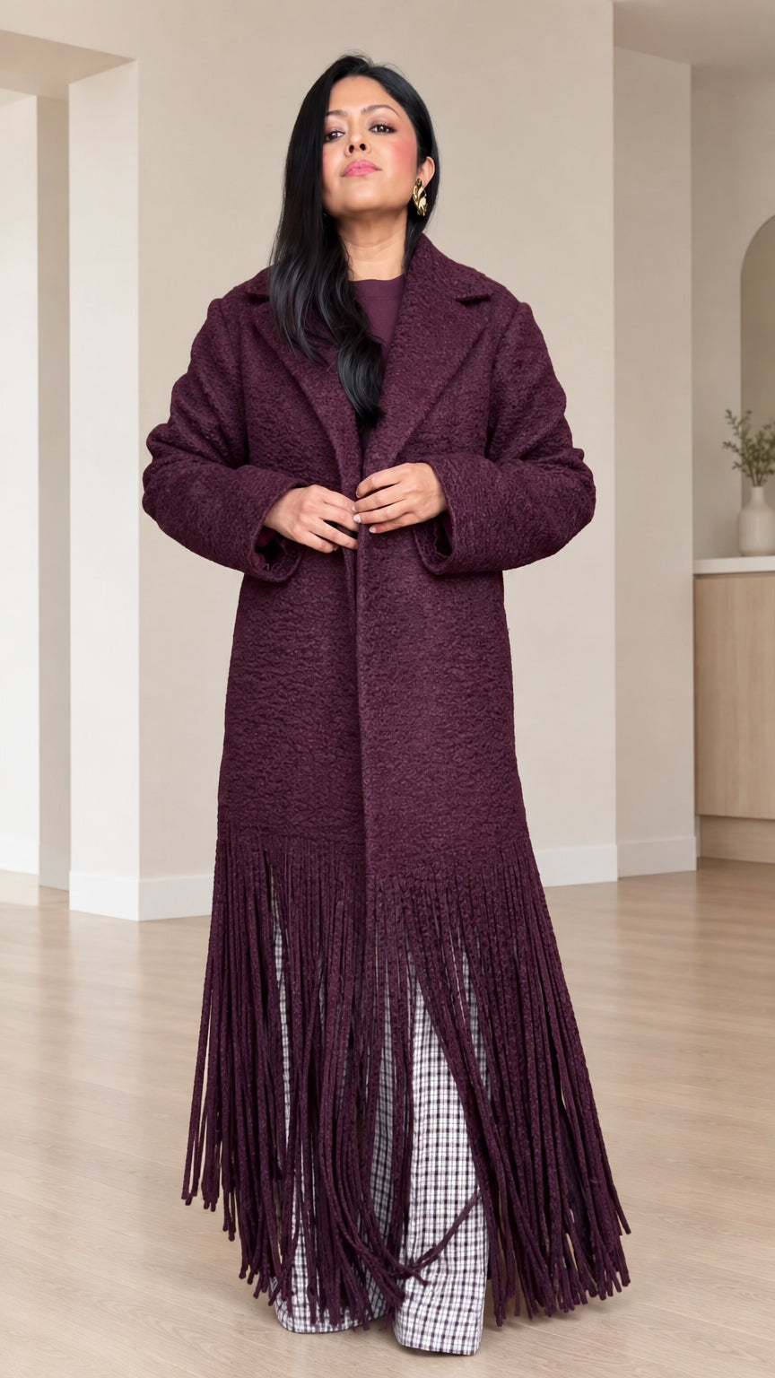 Full front view of model wearing Deep Burgundy textured bouclé maxi coat with fringe hem