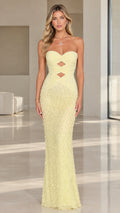 Front view of model wearing pale yellow strapless cutout ruched maxi gown with embellished skirt