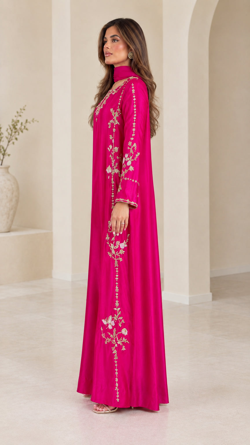 Side profile view of fuchsia long sleeve embroidered maxi dress