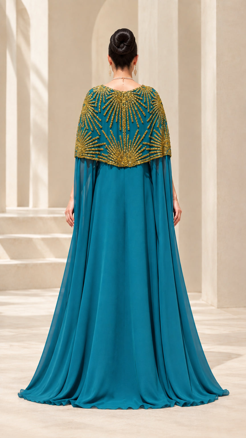 Back view of teal blue formal gown with flowing floor-length cape