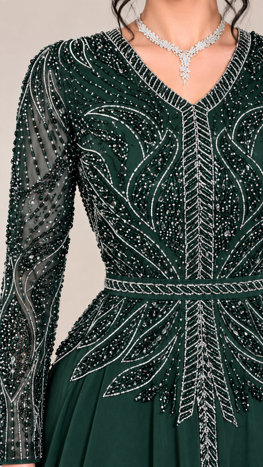 Close-up of intricate rhinestone and beadwork on green bodice and sleeves